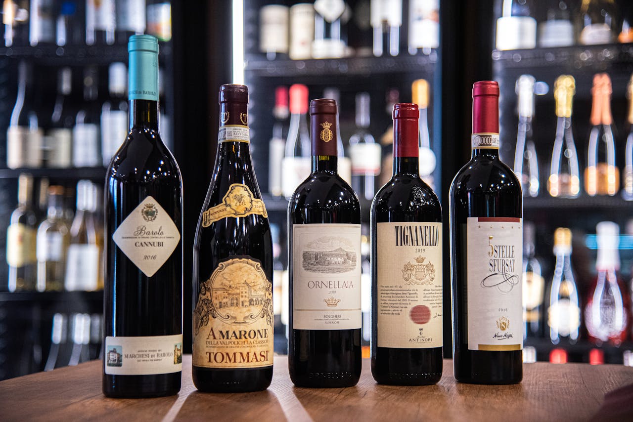 A premium collection of Italian red wines elegantly displayed in a wine store setting.